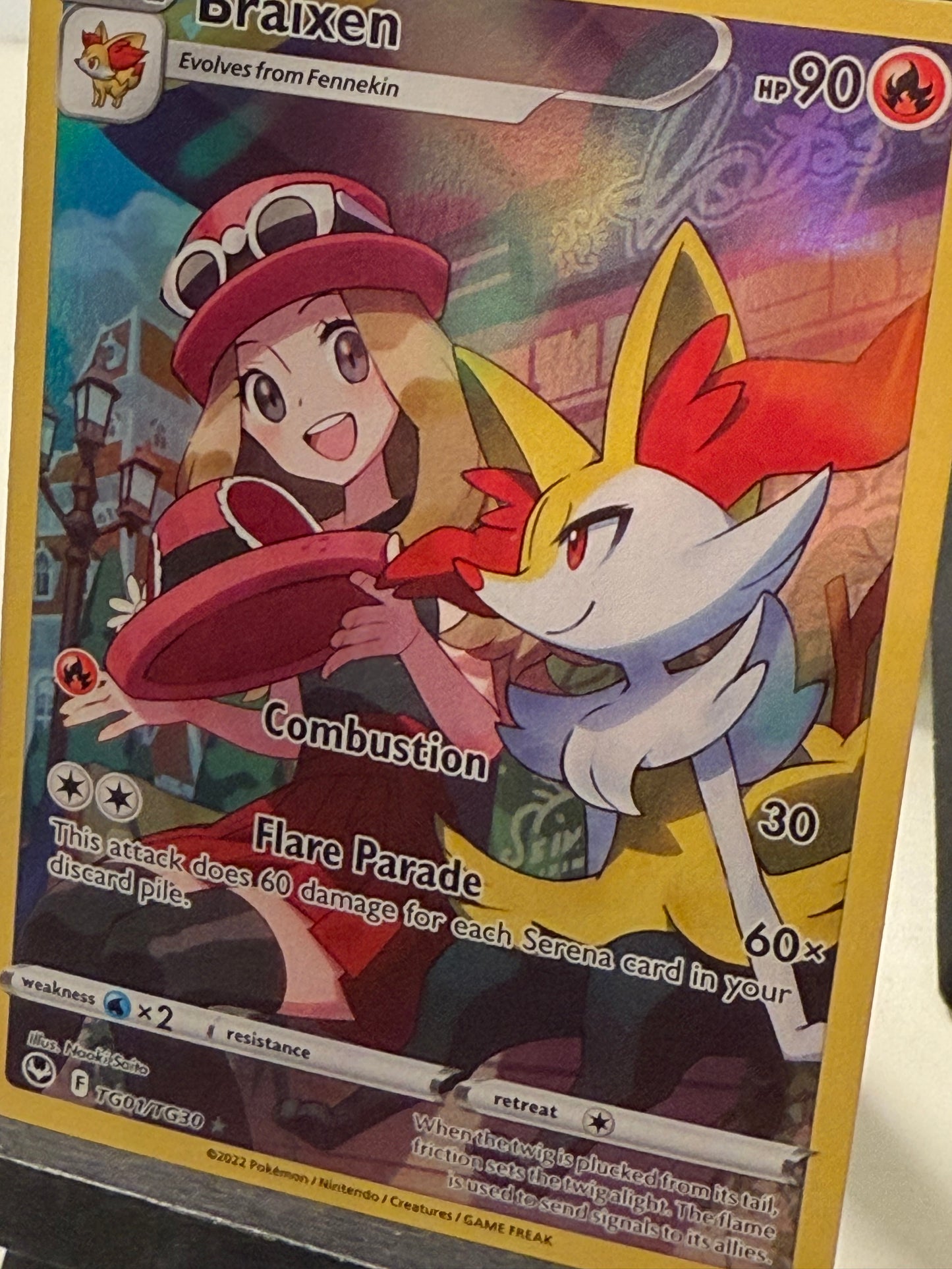 Pokémon trading card featuring a character with red and white fur, set against a colorful background.